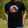 Man wearing a black unisex T-shirt with a "Bears" design featuring a bear watching over a tent in a colorful forest.