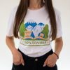 Woman wearing a white unisex T-shirt featuring an illustration of Stara Planina mountains, trees, a house, and the text "Стара Планина" in Cyrillic.