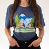 teniska-damska-siva-za-planinarka-stara-planina Woman wearing a dark gray unisex T-shirt featuring an illustration of Stara Planina mountains, trees, a book, and the text "Стара планина" in Cyrillic.