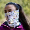 bandana-za-planina-zhenska-maska Woman wearing a multifunctional buff with Bulgarian mountain names and hiking-themed illustrations, made from recycled R-PET.