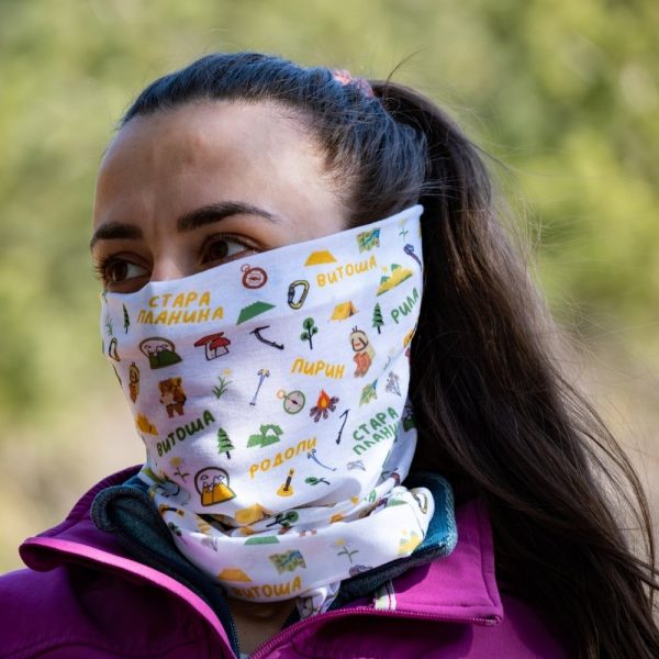 bandana-za-planina-zhenska-maska Woman wearing a multifunctional buff with Bulgarian mountain names and hiking-themed illustrations, made from recycled R-PET.