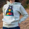 hoodie-sweatshirt-zelen-cvyat-za-momiche Light green hoodie with a colorful bear and mountain design, worn by a woman outdoors.