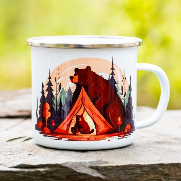 White enamel camping mug featuring an illustration of a bear sitting protectively outside a tent, while a bear cub sits inside, surrounded by a forest at sunset.