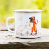 White enamel camping mug featuring an illustration of a young female hiker with a backpack and trekking pole, walking through rolling hills under a bright sun.