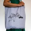 Eco-friendly reusable tote bag made from 80% recycled cotton and 20% recycled polyester. Light gray with a black mountain photography print.