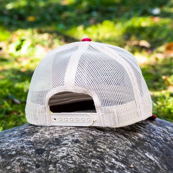 Back view of a trucker hat with mesh design and adjustable strap.