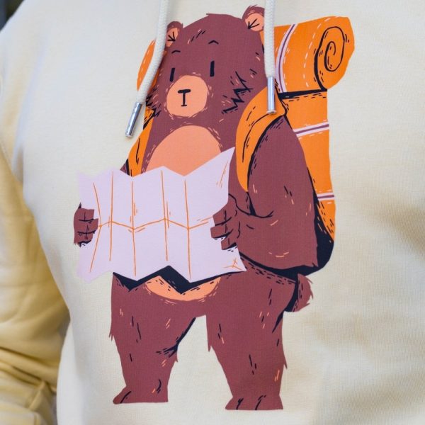 swearshirt-hoodie-zhylto-mechka Close-up of a yellow hoodie featuring a printed design of a hiking bear holding a map.