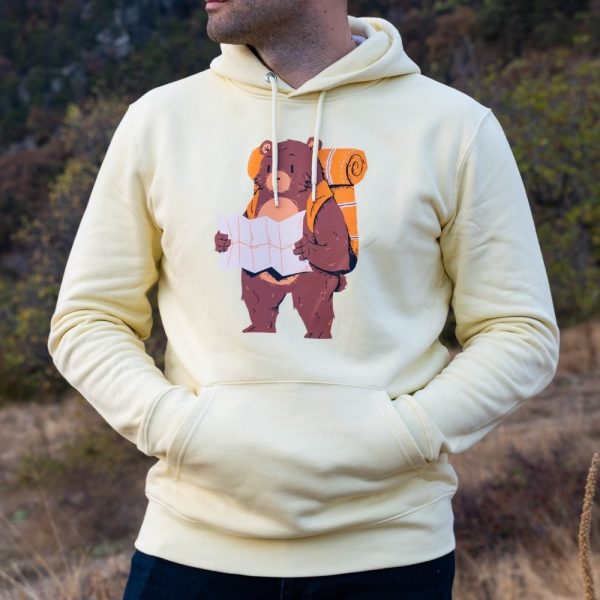swearshirt-hoodie-zhylto-momche Yellow hoodie with a hiking bear print, worn by a man outdoors.