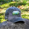Vintage black baseball cap with an embroidered bear and mountain landscape design.