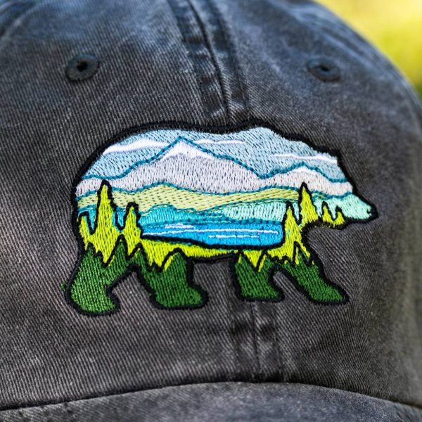 Vintage black baseball cap with an embroidered bear featuring a mountain landscape design.