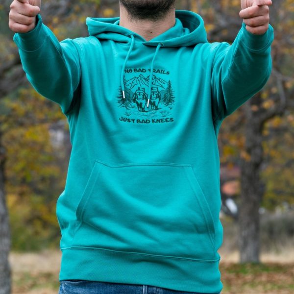 myzhko-hoodie-sweatshirt turquoise men's hoodie with quote “No bad trails just bad knees” shown outdoors with hiker illustration