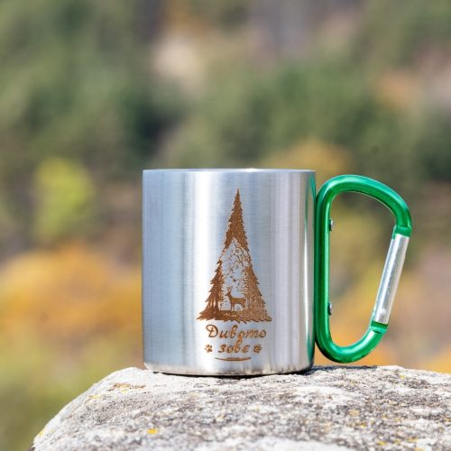 Stainless steel mug with laser-engraved “The Wild Calls” deer and forest design, featuring a green carabiner handle.