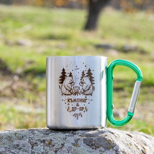 Stainless steel camping mug with laser-engraved bear design and green carabiner handle.