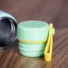 mini-malyk-termos-za-voda Close-up of mint green mini thermos cap with yellow carrying handle.