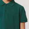 Close-up of a kids' Glazed Green polo shirt made from 100% organic cotton, showing the classic collar, button placket and premium piqué fabric texture.