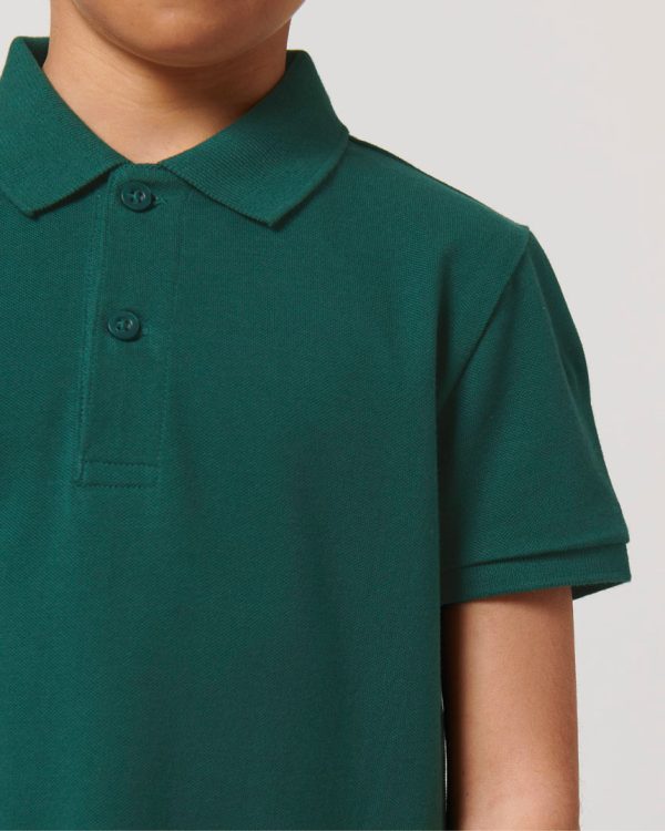 Close-up of a kids' Glazed Green polo shirt made from 100% organic cotton, showing the classic collar, button placket and premium piqué fabric texture.