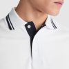 Close-up detail of a premium white cotton polo shirt with navy contrast collar and placket made from heavyweight 230 gsm cotton