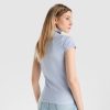 Back view of women's light blue cotton polo shirt 190 gsm for corporate workwear, branding, embroidery, DTF printing and promotional campaigns.