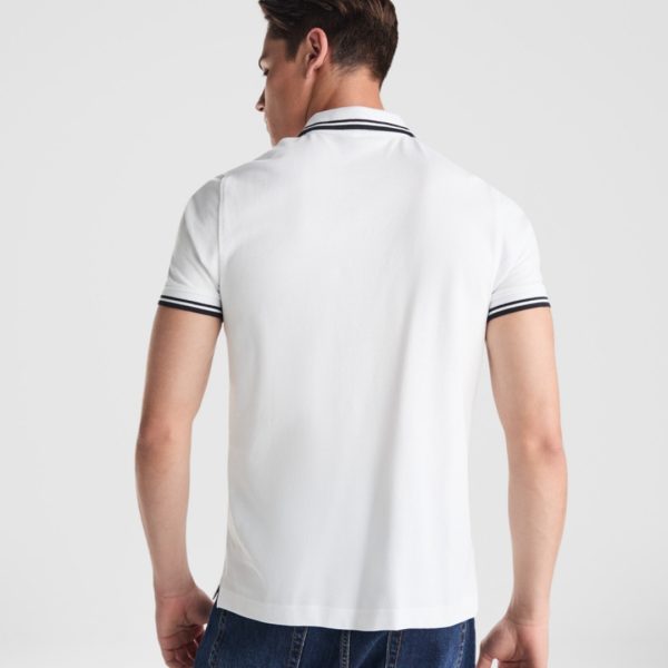 Back view of a premium white cotton polo shirt with navy contrast collar and sleeve details made from heavyweight 230 gsm cotton