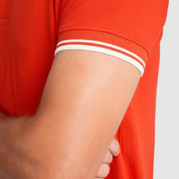 Close-up detail of the sleeve cuff on a premium red cotton polo shirt with white contrast stripes made from heavyweight 230 gsm fabric